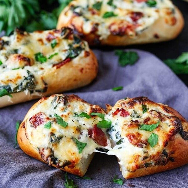 These stuffed cheesy breads with spinach and bacon use part-baked petit pans that cook at the same time as the gooey filling. Perfect for game day!!