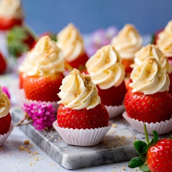 Cheesecake stuffed strawberries on a marble chopping board