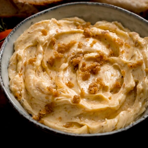 Square image of chicken skin butter in a grey bowl