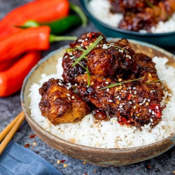 This Chinese Crispy Chicken with Honey Garlic Sauce is one of those meals everyone loves! Easy to make spicy or mild. Way tastier than takeout!