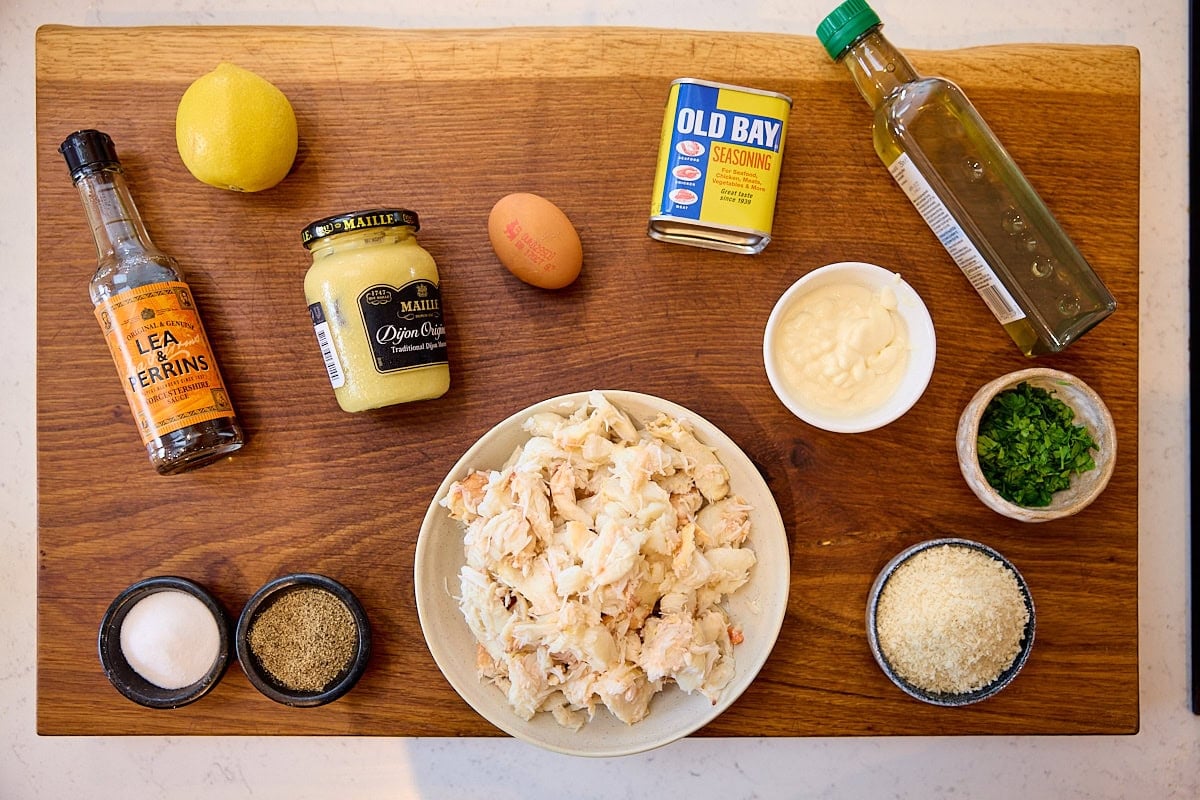 Ingredients for crab cakes on a wooden board