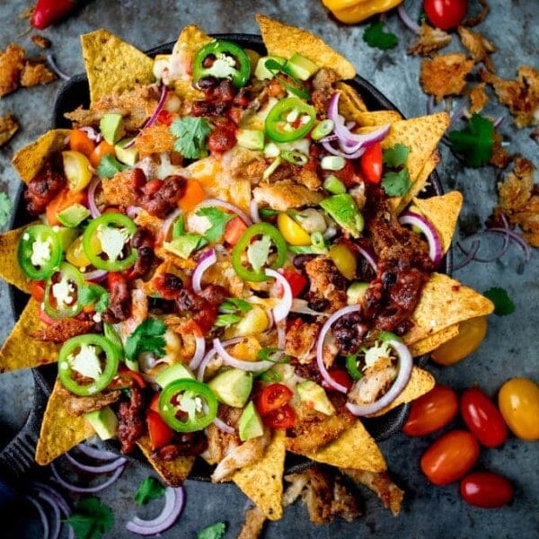 What should you do with all that leftover turkey....Make these Crispy Turkey Nachos!! Crispy fajita-spiced turkey, beans, and a ton of melted cheese!!!