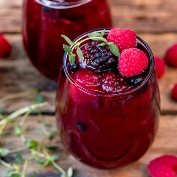 New Year's Eve Rum Berry Cocktail! With rum, Cointreau, pomegranate juice and ginger beer! Use frozen berries instead of ice cubes to finish the look!