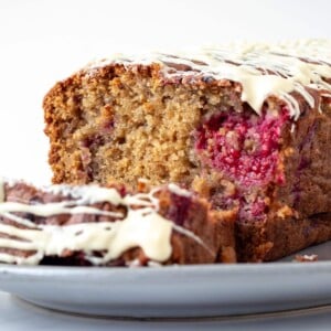 close up picture of a raspberry and white chocolate cake showing the internal fluffy texture of the cake.