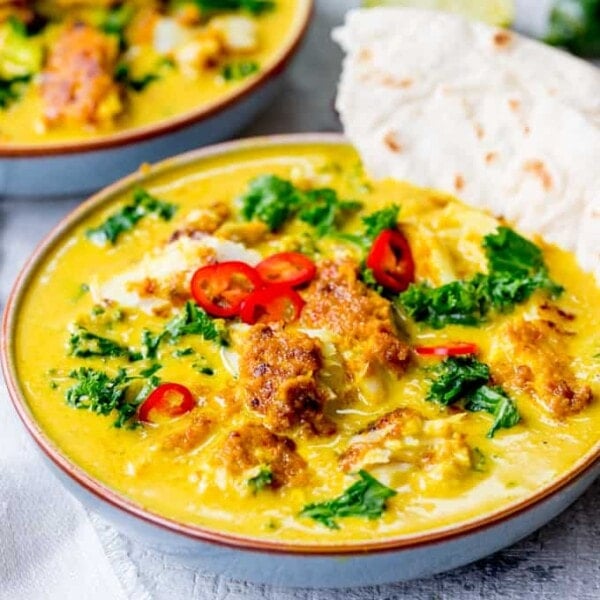 Square image of Thai fish yellow curry with kale.