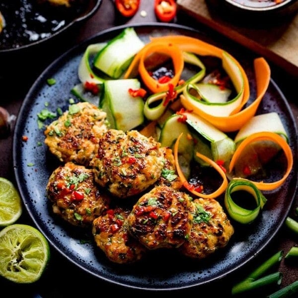 Thai Fishcake Bites and vegetable ribbons on a dark plate