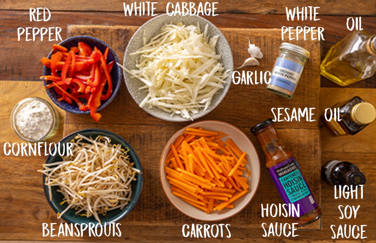 Labelled ingredients for making the filling for vegetable spring rolls.