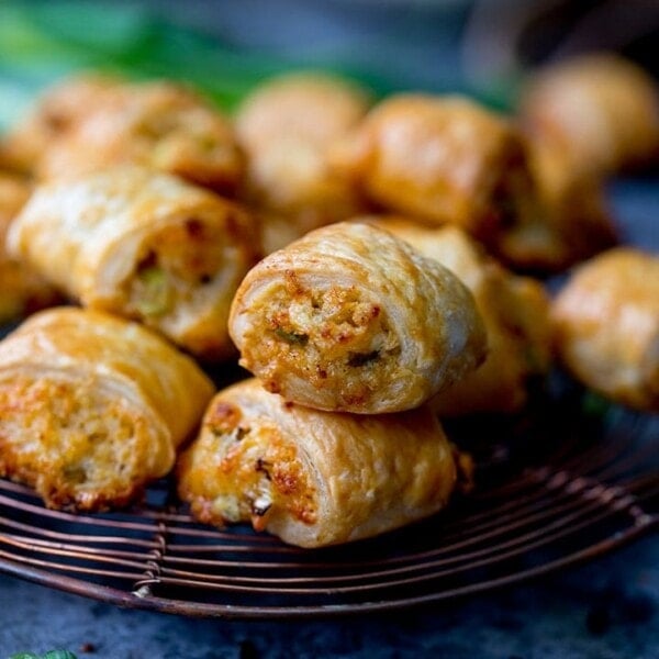 Vegetarian sausage rolls piled up on a cooling rack