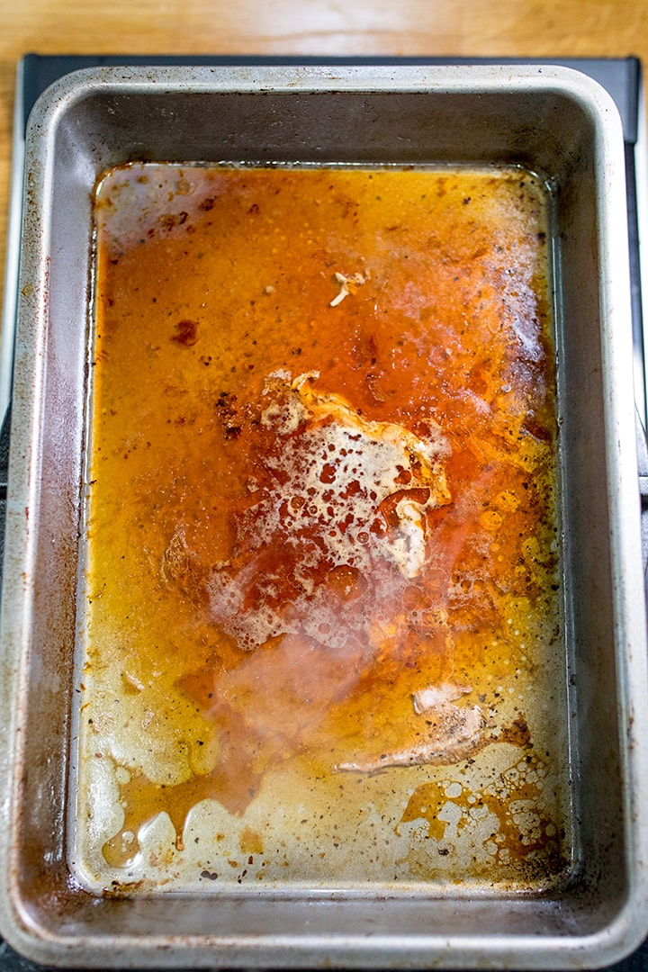 Heating meat juices for gravy in a roasting tin