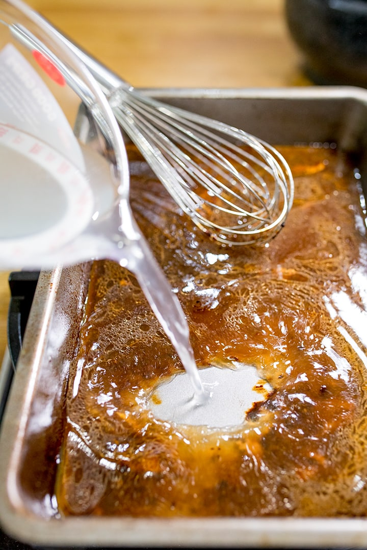 Adding vegetable stock to meat juices for gravy